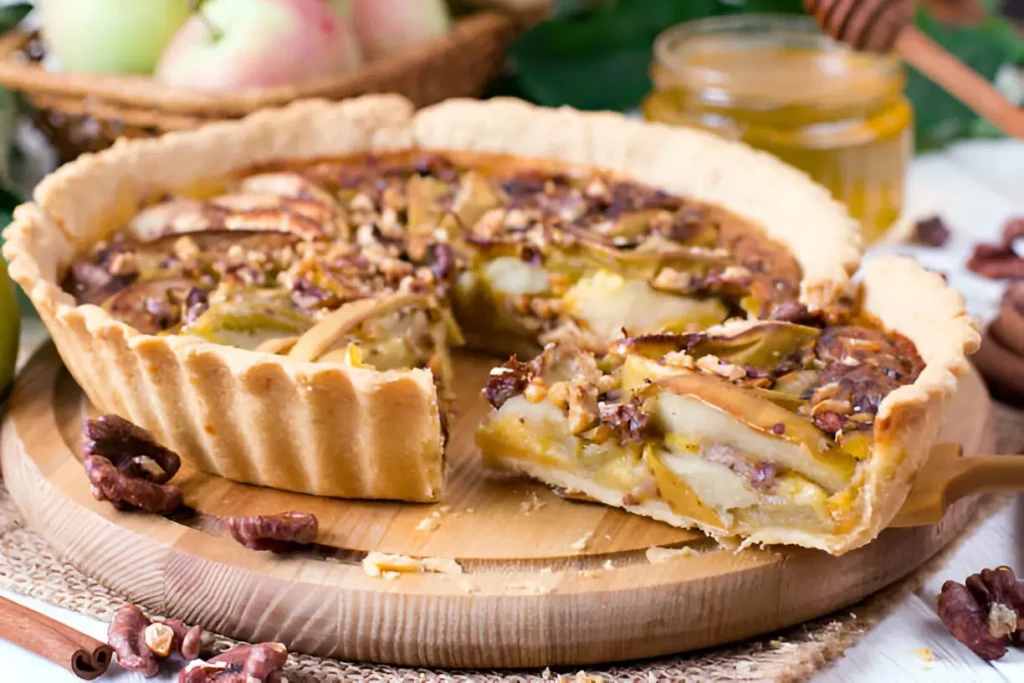 Image of a beautifully sliced apple and pecan tart, showcasing a golden-brown crust filled with caramelized apples and pecans, garnished with a sprig of mint.