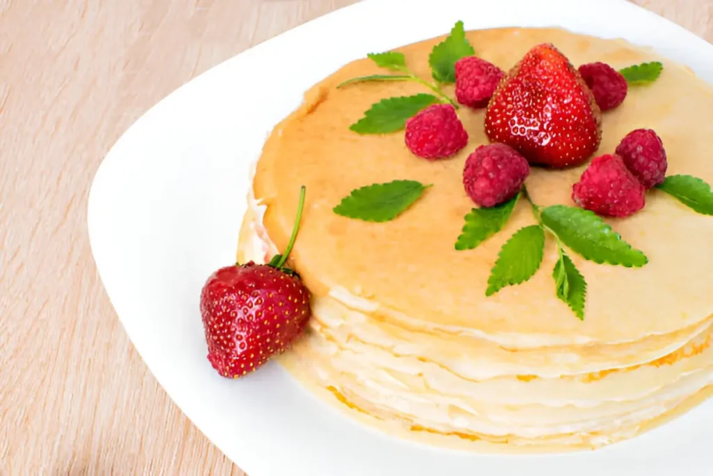 Image of a vibrant CMS Pancake Breakfast spread, featuring stacks of pancakes with various toppings like syrup, fruits, and whipped cream.