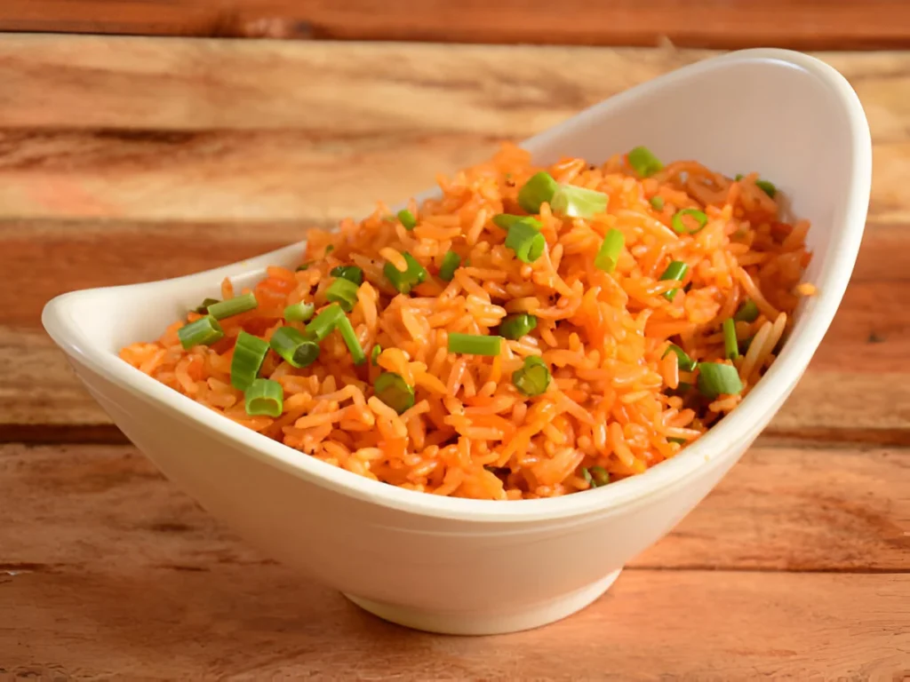 A vibrant bowl of red rice pilaf garnished with fresh herbs and colorful vegetables.